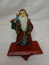 Vintage Cast Iron Base Resin Santa Stocking Holder Toys Bells Doll Saint Nick