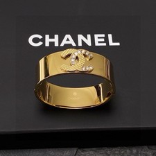 CHANEL Gold Metal Bangle Bracelet with Crysta...