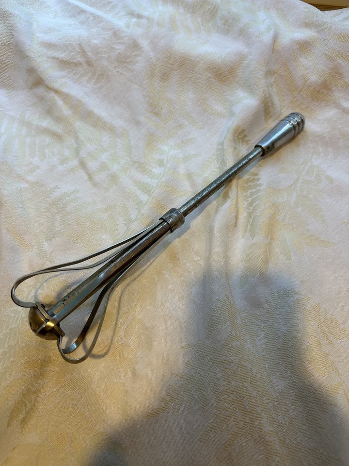 A spring-loaded hand mixer from the pre-electric era — the satisfying mechanical action and retro branding make it a genuine conversation piece for any vintage kitchen lover.