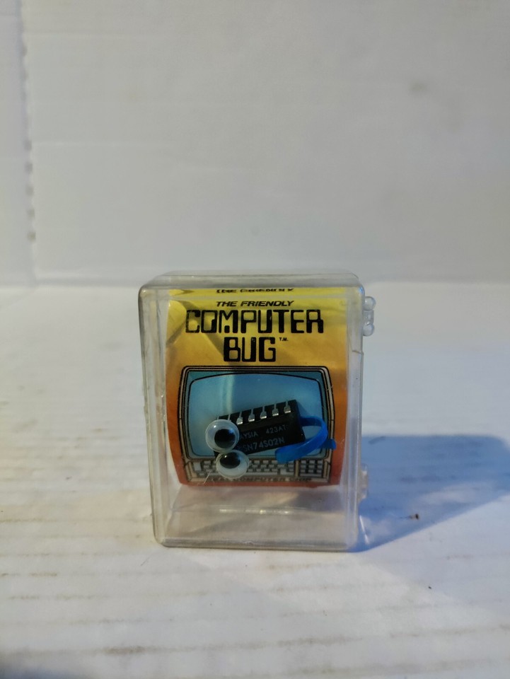 A cheerful 1980s novelty computer chip bug — a tiny retro tech artifact that's equal parts kitsch and nostalgia, perfect for a cubicle or desk.