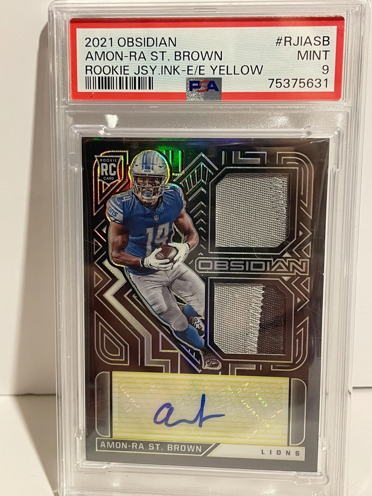 Amon-Ra St. Brown Panini Obsidian Rookie Jersey Ink #RJIASB Electric Etch Yellow