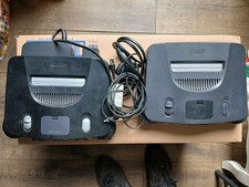 2x Nintendo 64 Consoles one powering up one NO NOT no controllers 1 power brick