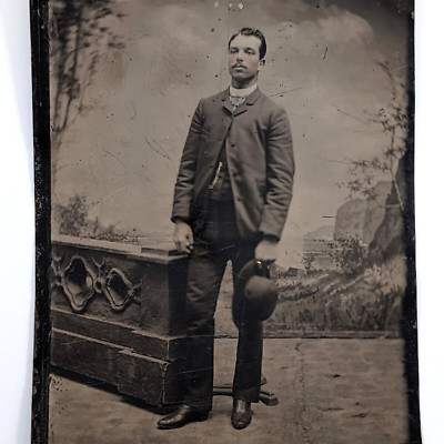 Tintype Photo Dapper Man Holding Hat Posing Stand Painted Backdrop