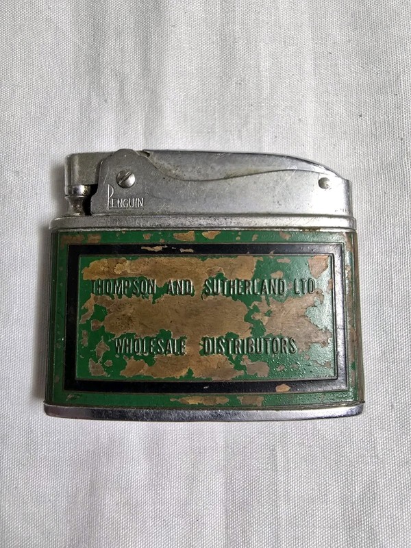 Vintage Penguin Thompson & Sutherland Advertising Flat Lighter. RARE
