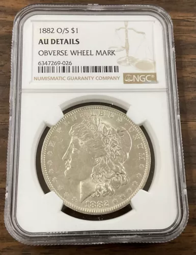 1882 O/S SILVER DOLLAR $1 NGC  AU DETAILS  OBVERSE WHEEL MARK ON NECK