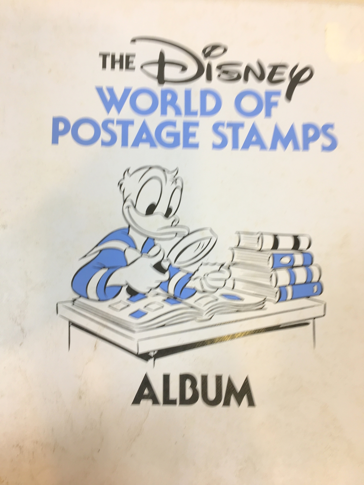 DISNEY WORLD OF POSTAGE STAMPS ALBUM, WITH SOME STAMPS