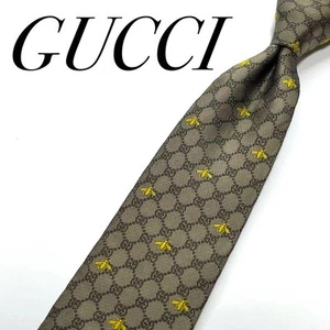 GUCCI Cravate étroite motif GG logo abeille doré