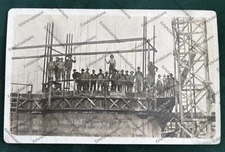 RPPC men building something large construction site workers Real Photo Postcard