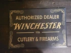 VINTAGE WINCHESTER FIREARMS CUTLERY DEALER 1936 TIN OVER CARDBOARD SIGN GAS OIL
