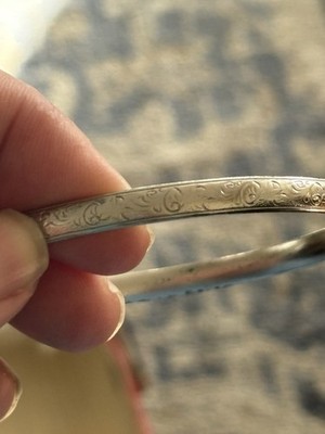 Vintage sterling silver bangle with engraved scrolling acanthus leaf design.