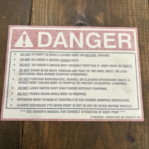 DANGER "do not" raise loaded body warning decal # 04049-321-00 w/paint cover.