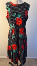 Elegant cocktail dress with polka dots and red flowers 1950s style 