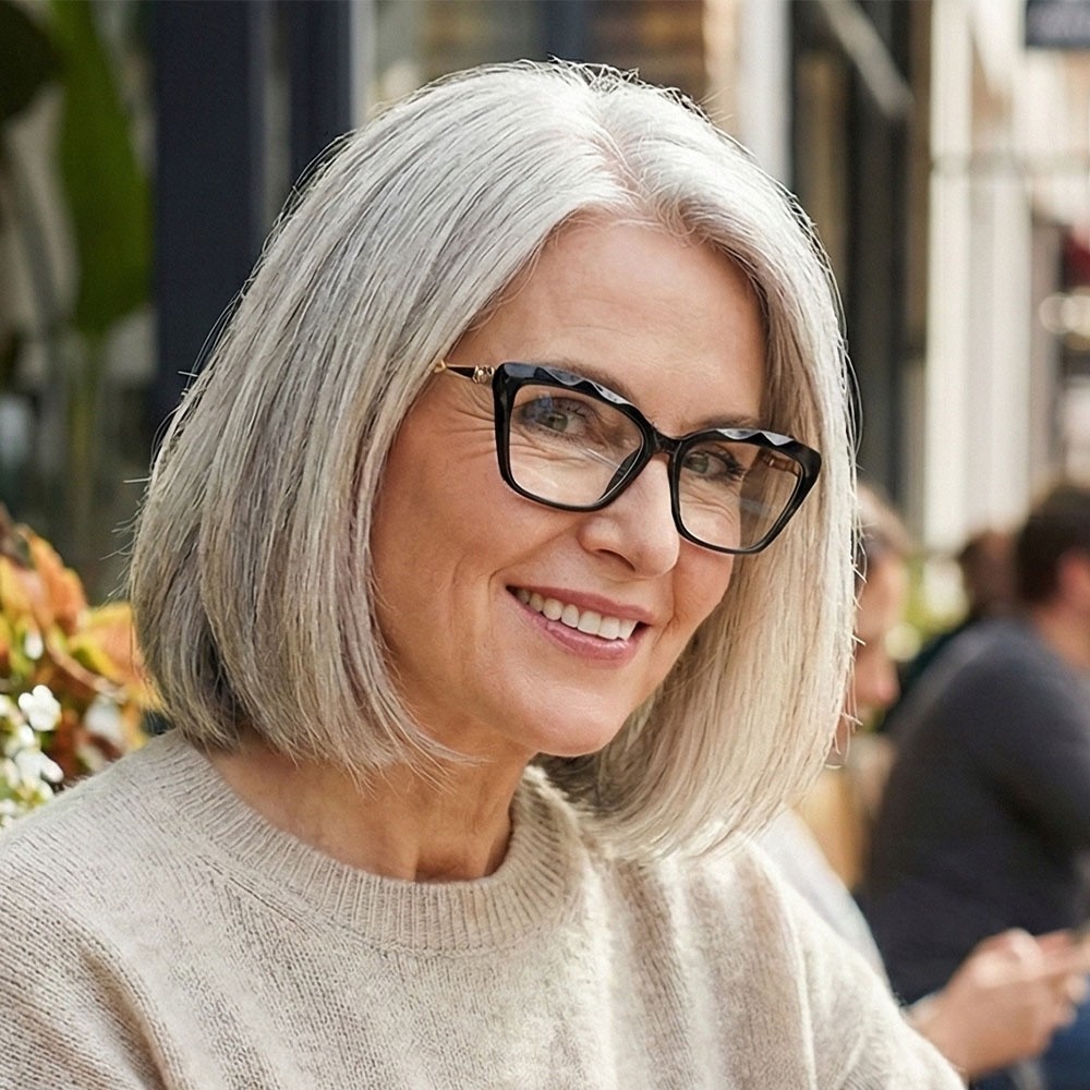Elegant black cat-eye reading glasses with a textured diamond-patterned brow and gold decorative link hinges.