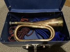 Cased antique copper and brass military bugle with rope colours