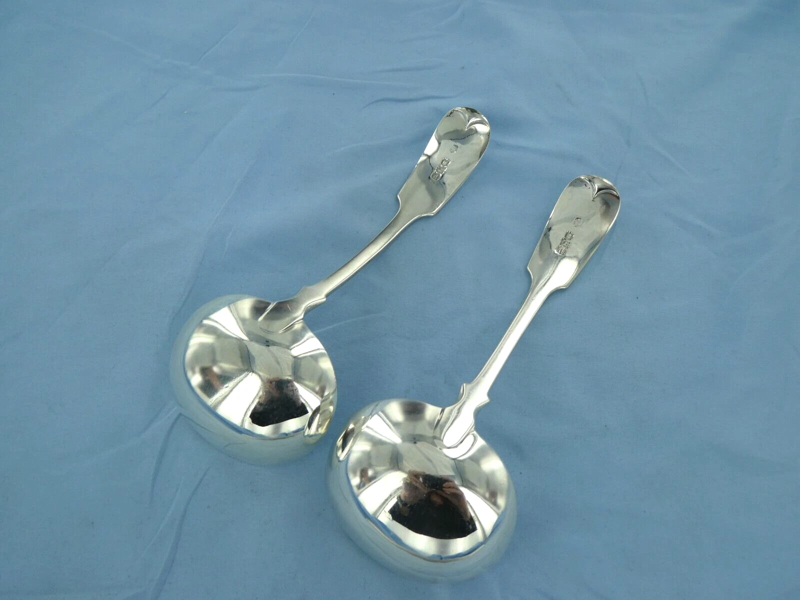 AN ANTIQUE PAIR OF STERLING SILVER FIDDLE BACK SAUCE LADLE, LONDON 1899.