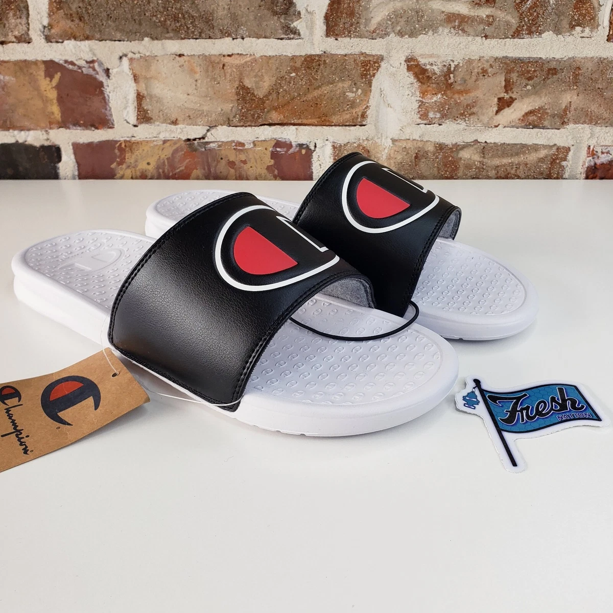 Champion black hotsell and white slides