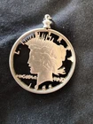 1922 cut out silver peace dollar. in bezel. smooth back.