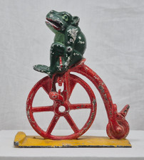 Antique Professor Pug frog on High Wheel Bicycle, a part of Mechanical Bank
