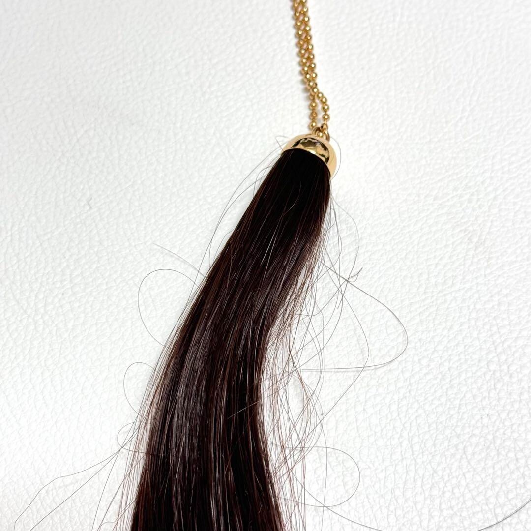 MAISON MARTIN MARGIELA Gold necklace with a lock of brownish hair 
