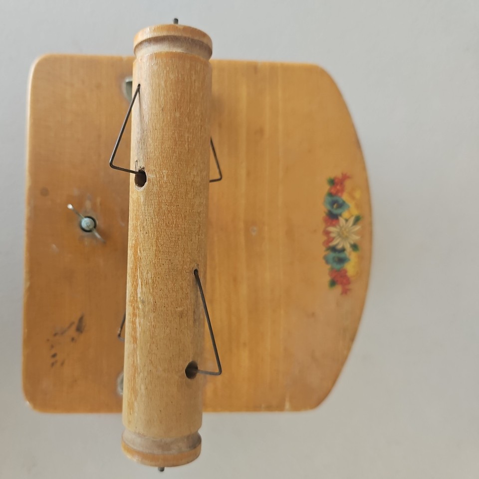 A Swiss Befag music box hidden inside a wooden toilet paper holder — wildly niche, fully functional, and absolutely the most unexpected bathroom conversation starter imaginable.