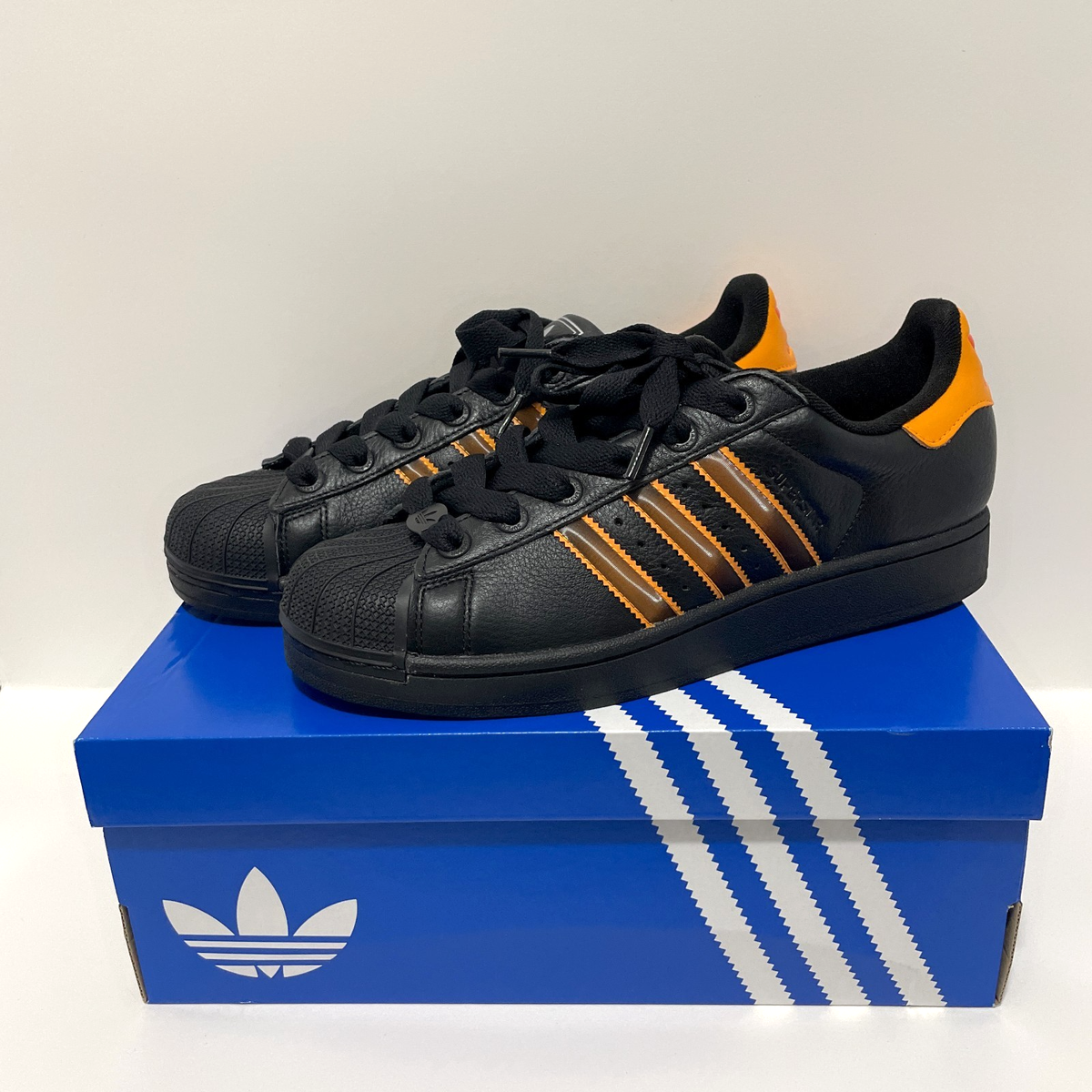 black and orange adidas shell toes