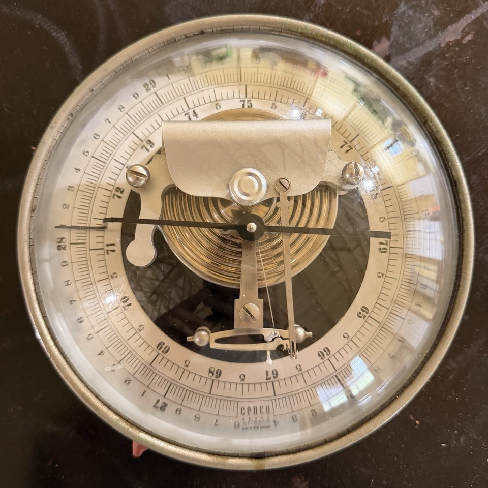 A vintage West German aneroid barometer with visible movement — a gorgeous piece of analog weather science you can actually see working.