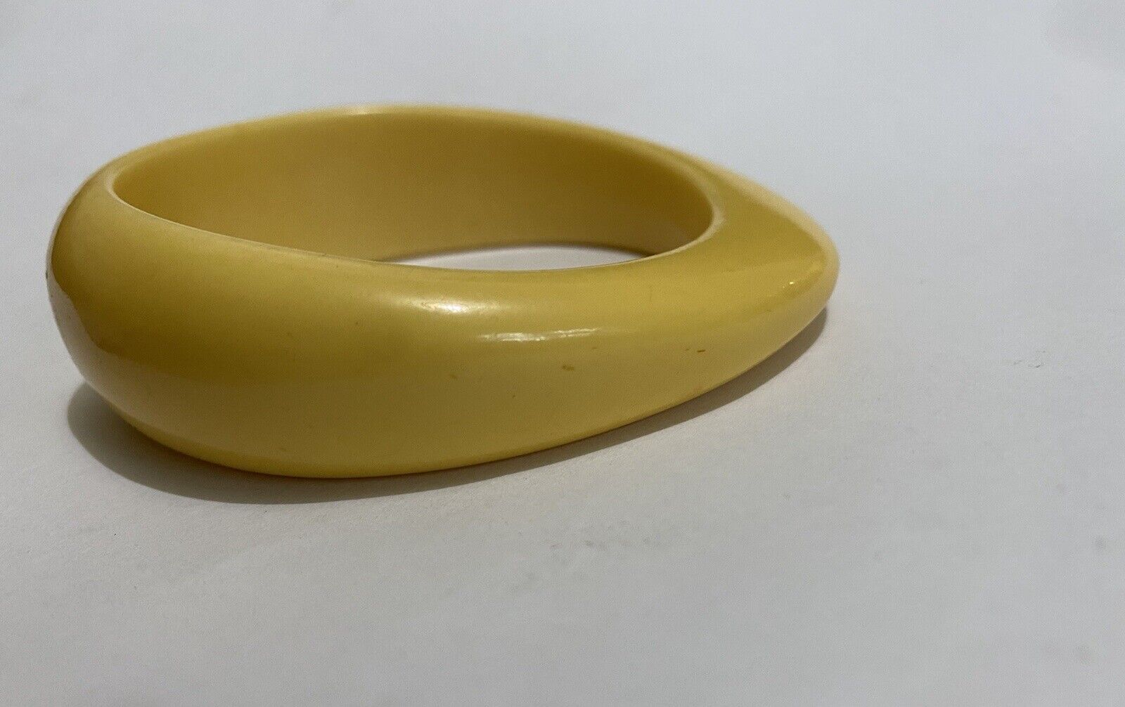 vtg asymmetrical banana yellow bakelite bangle Eg… - image 1