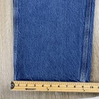 Blue denim Y2K Carhartt men’s carpenter jeans with faded thighs, five-pocket design, and visible stitched seams.