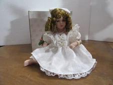Porcelain doll in beautiful white dress, hair bow, possibly Heritage signature