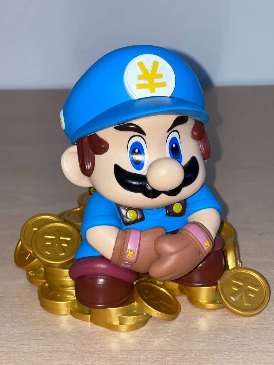 Figura Mario Bros sentada sobre Monedas Nintendo