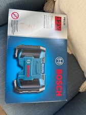 Bosch PB120 12V jobsite radio comes with an AC adapter that stores in the back 
