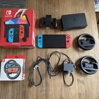 Nintendo Switch 64GB OLED Blue/ Red OLED + Mario Kart 8 + Joy Con Wheels