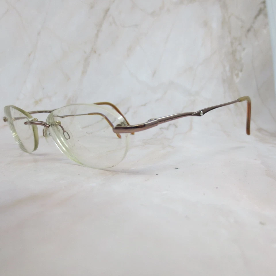 Marco de gafas Revlon bronce cálido RV512 oro rosa sin montura ovalado 49-16-135 Foto 2 de 4