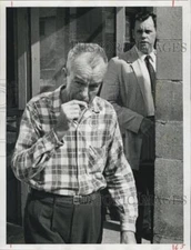 1961 Press Photo Grocer Seeber Stokes smokes a cigarette. - RSG78267