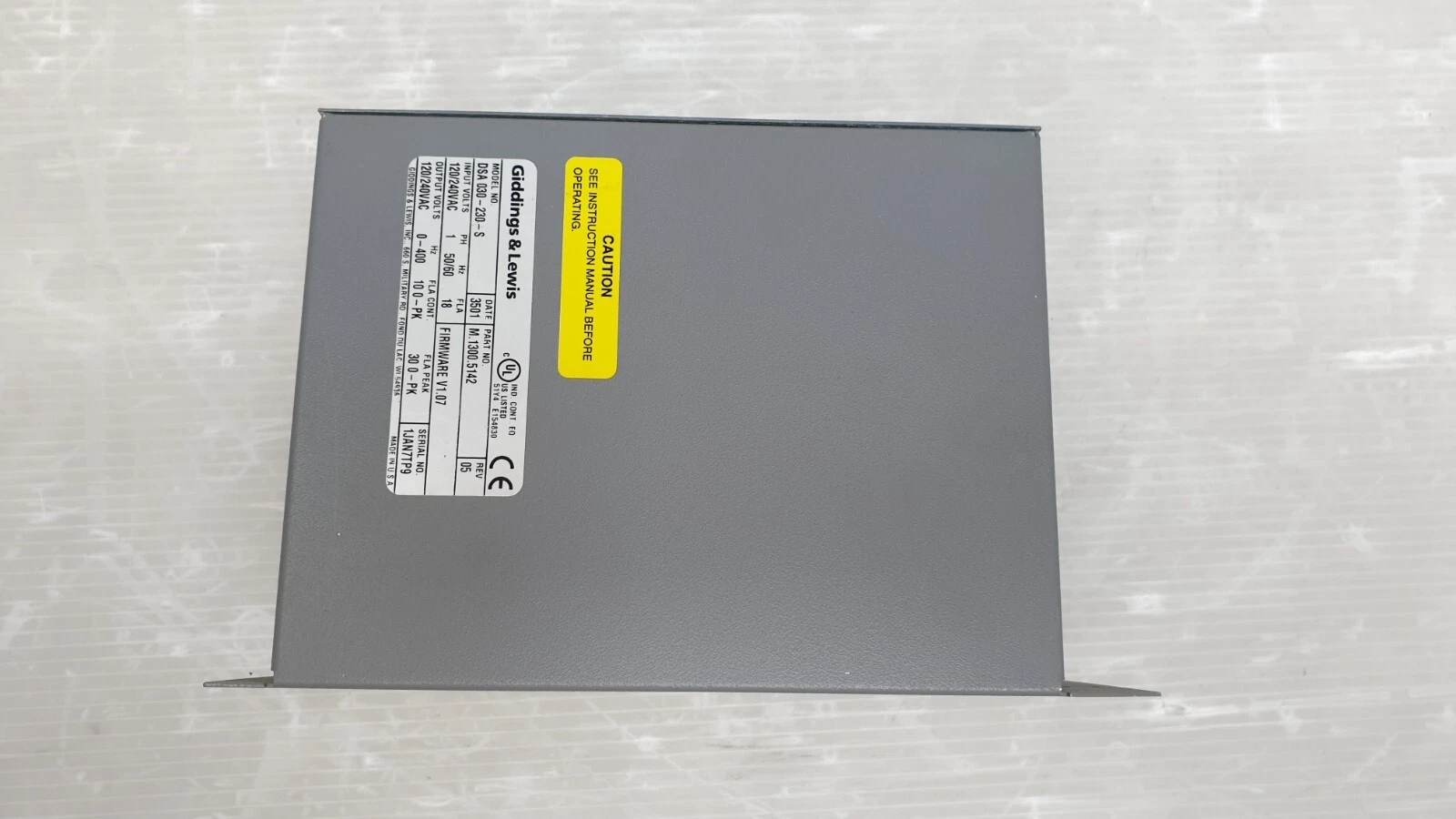 Side of the DSA-030-230-S housing with nameplate and yellow caution label