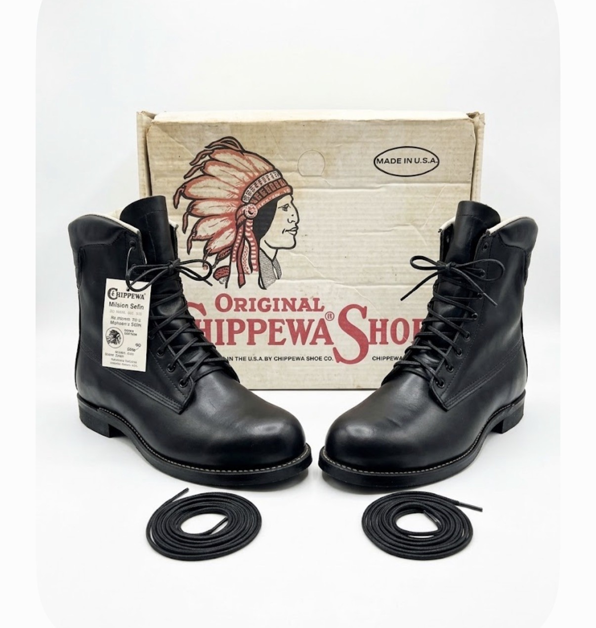 Black leather Chippewa steel toe work boots with black laces, brown soles, and box labeled “Made in U.S.A.”