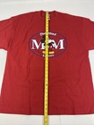 Red vintage Disneyland T-shirt with blue Mickey Mouse logo and “Disneyland Est. 1955” text, shown flat with yellow measuring tape.