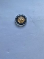 Gold full sovereign 2009 coin in protective capsule.