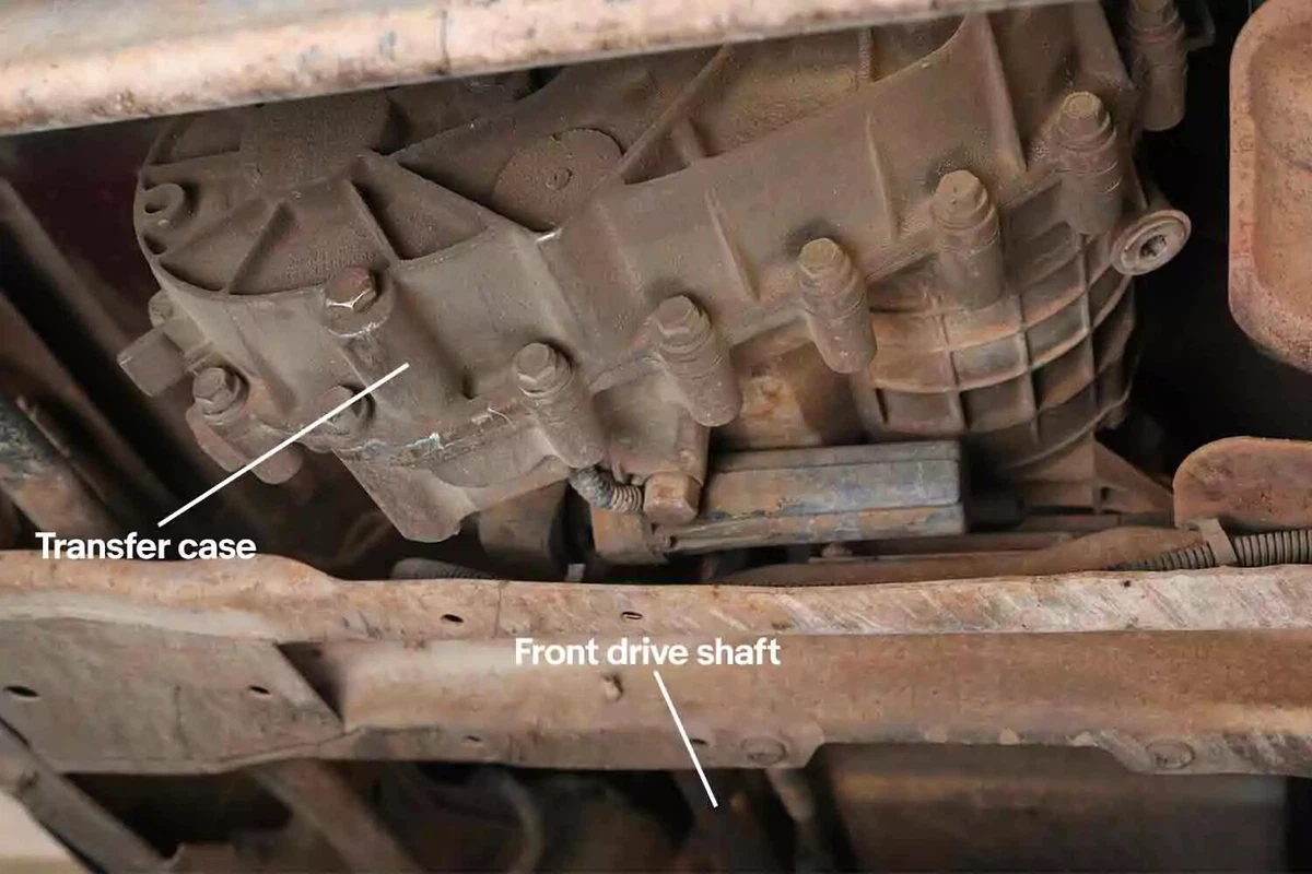 A vehicle's transfer case, behind the front drive shaft.