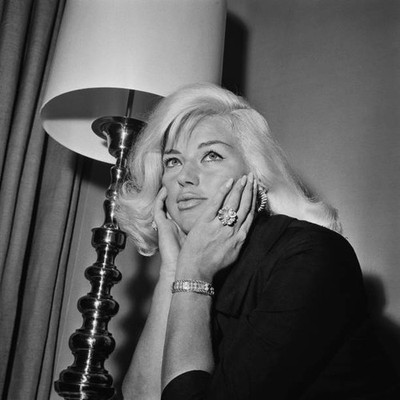 British actress singer Diana Dors her chin resting in her hands a - Old Photo