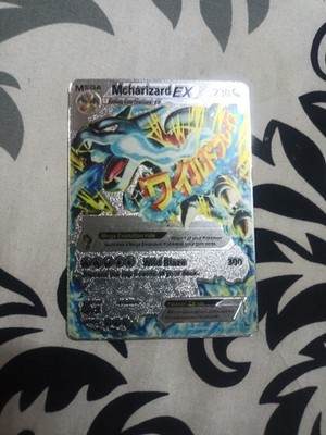 blue mega charizard pokemon card along with another foil promo card featuring Oricorio ex to help get more Fire Energy into play Mega Charizard EX 2014 Pokemon