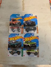 Lot of 4 hot wheels new multi series and vehicles blue,green, and red