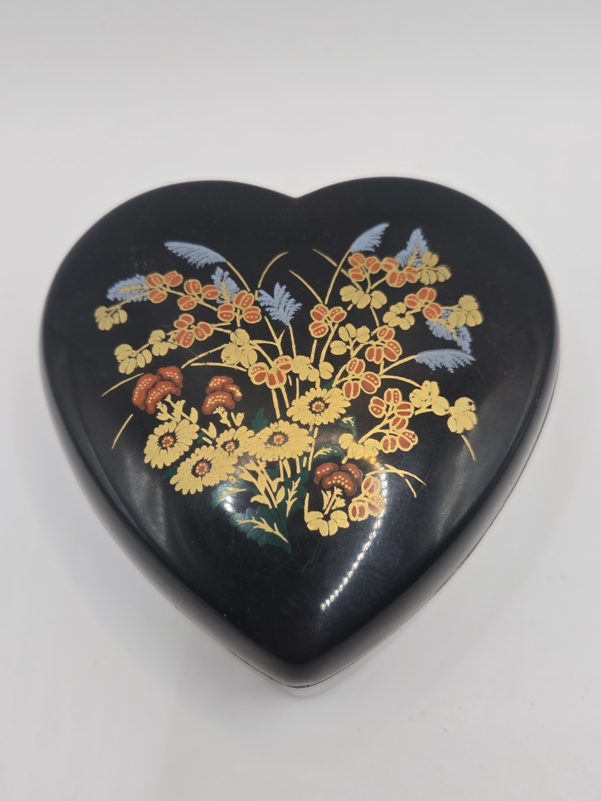 vintage black heart-shaped trinket box with a floral design.