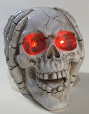 Halloween Decor Resin SKULL with hands on side of head and red light up eyes