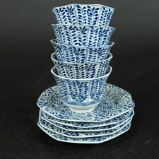 set blue and white cup and saucers with flowers