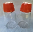 VINTAGE PAIR MCM 60s FEDERAL HOUSEWARES~SHAKER~ CLEAR GLASS~ORANGE TOPS W/COVERS