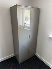 solid, gloss-grey two-door wardrobe with a hanging rail