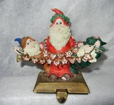 3 ELVES MERRY CHRISTMAS BANNER MOUNTED ON CAST IRON BASE STOCKING HANGER