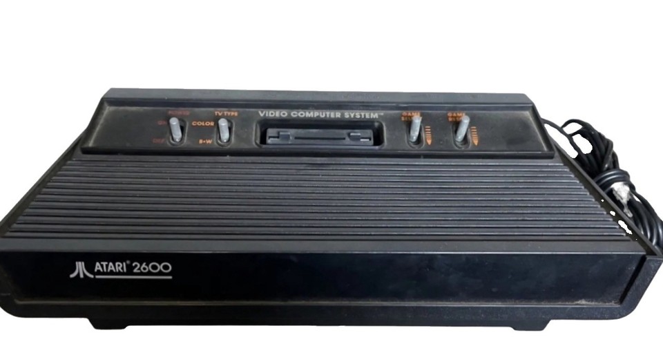 The iconic wood-grain Atari 2600 that launched home gaming — a fully tested, ready-to-play piece of pop-culture history.