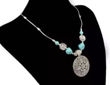 Long turquoise stoned necklace, with flower pendent